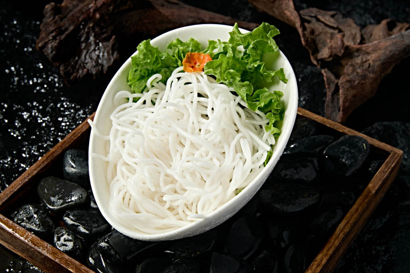 青色瓷盘装的火锅食材土豆粉条图片