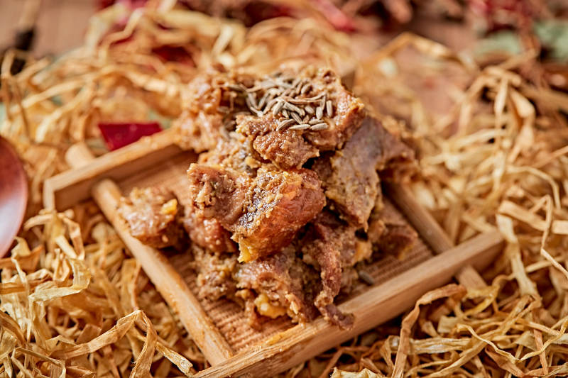 木质背景上摆放的自然香辣牛筋肉图片