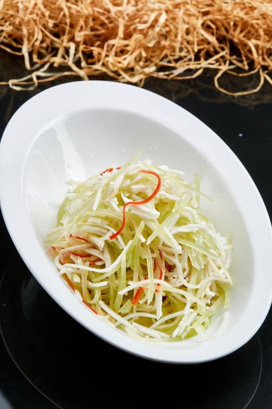 白色瓷盘装的巧拌双丝西芹丝土豆丝图片