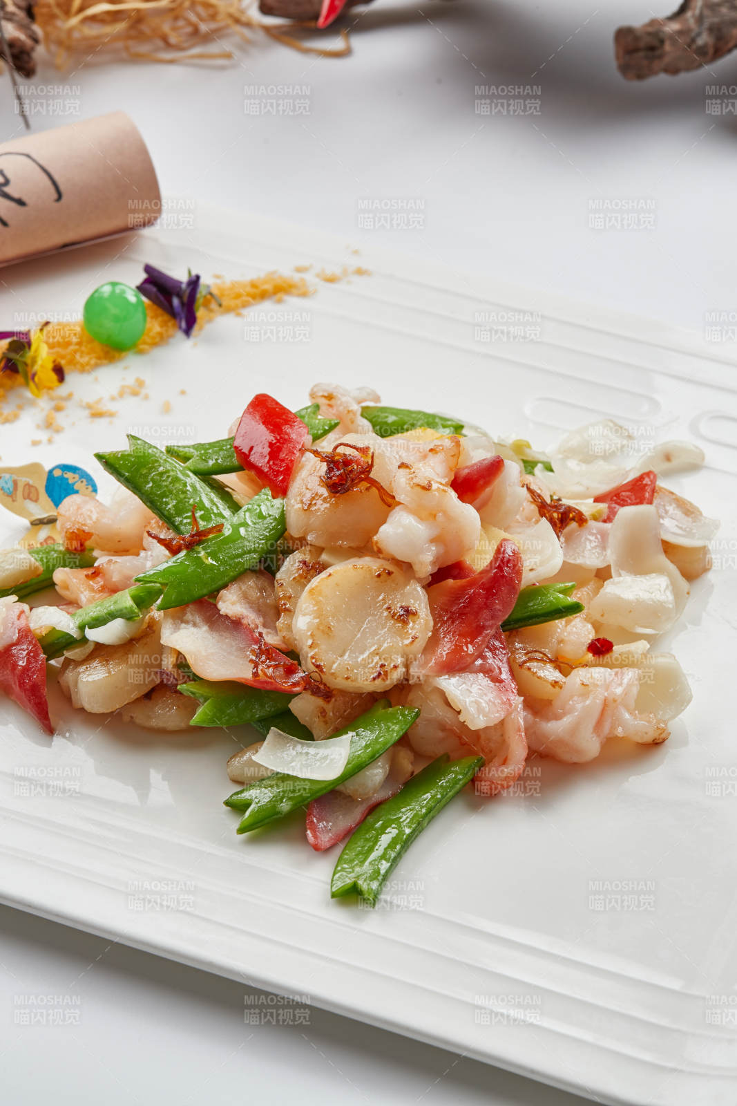 白色瓷盘装的的粤式小炒蜜豆炒海鲜图片