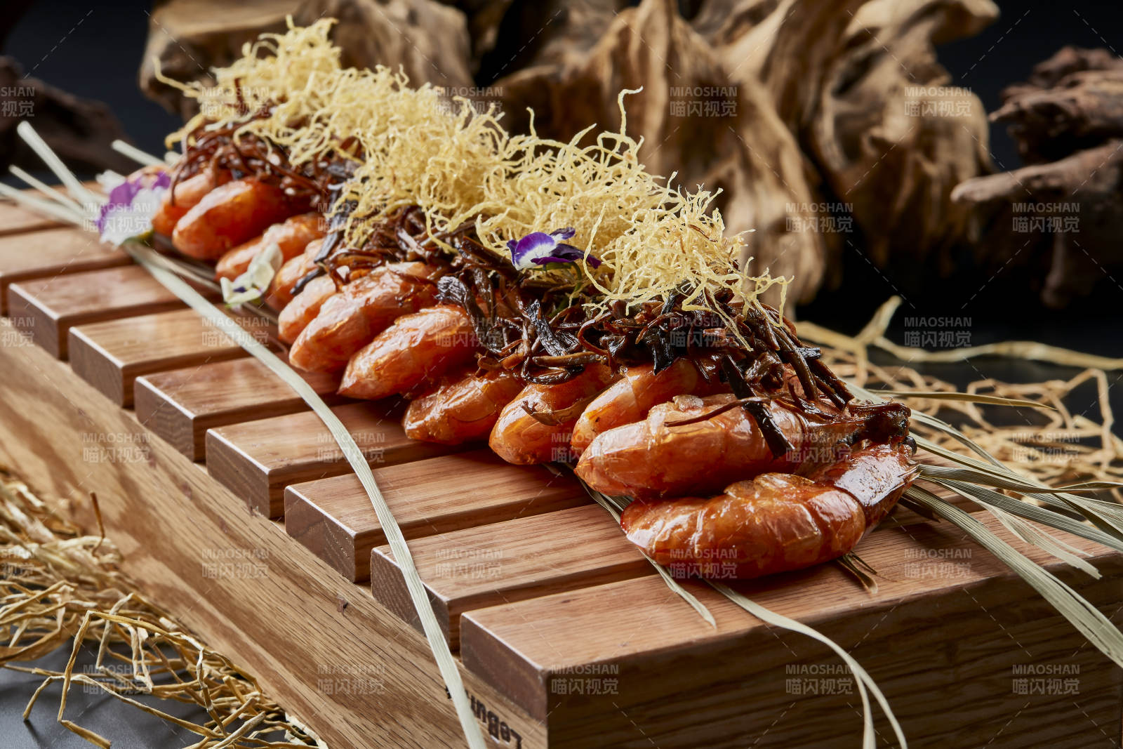 木质餐具上摆放的薯丝梅菜焗大明虾图片