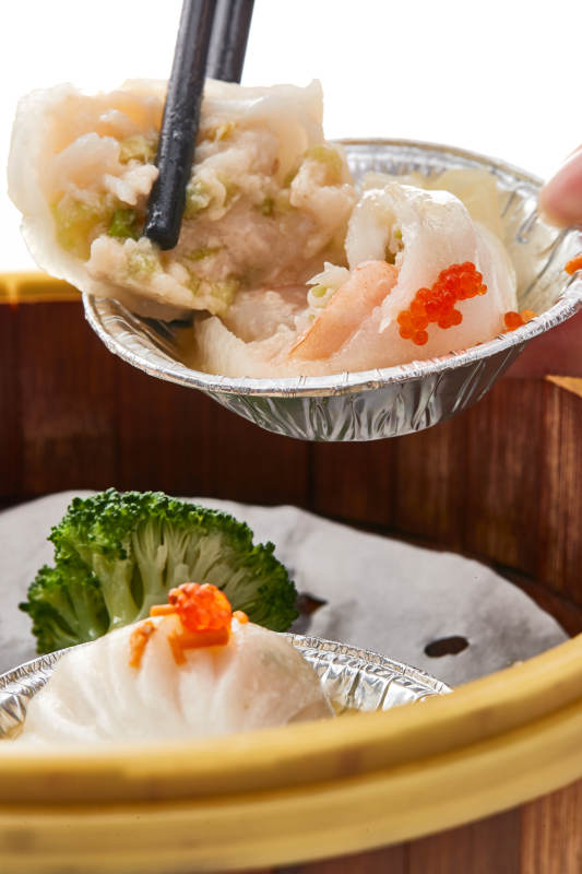 白色背景下精美竹笼屉装的港式茶餐蒸虾饺图片