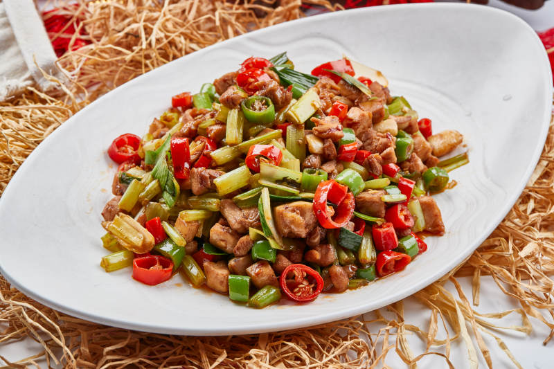 白色瓷盘装的的香辣西芹炒兔丁图片