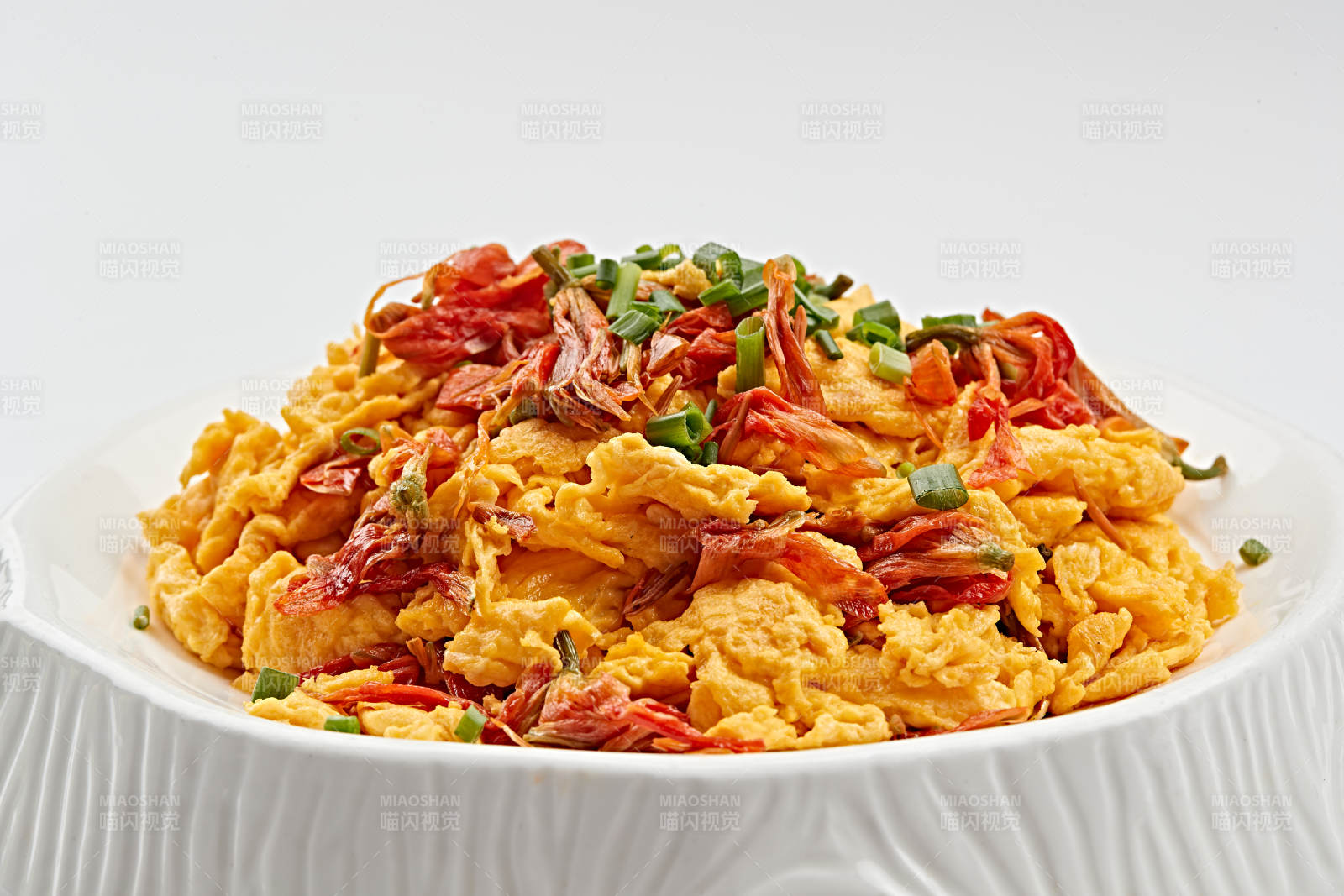 白色瓷盘装的赤百合炒鸡蛋图片