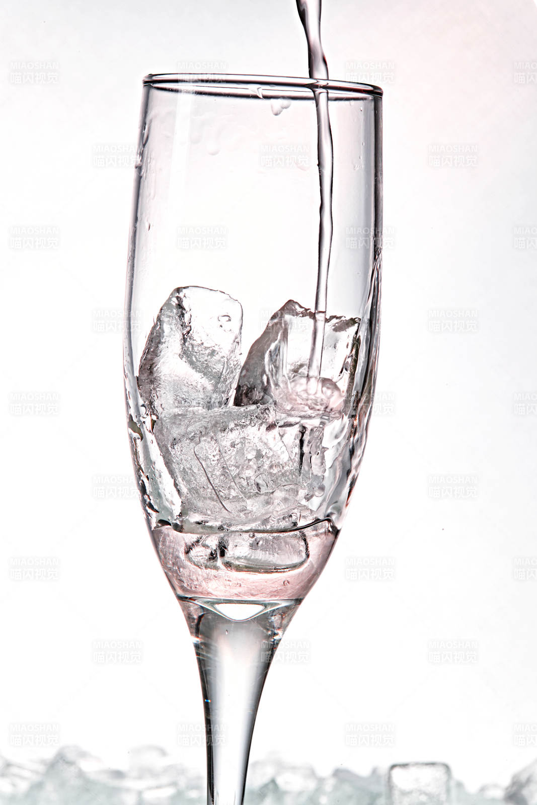 布满冰块的酒杯中的清凉桃子味预调酒图片