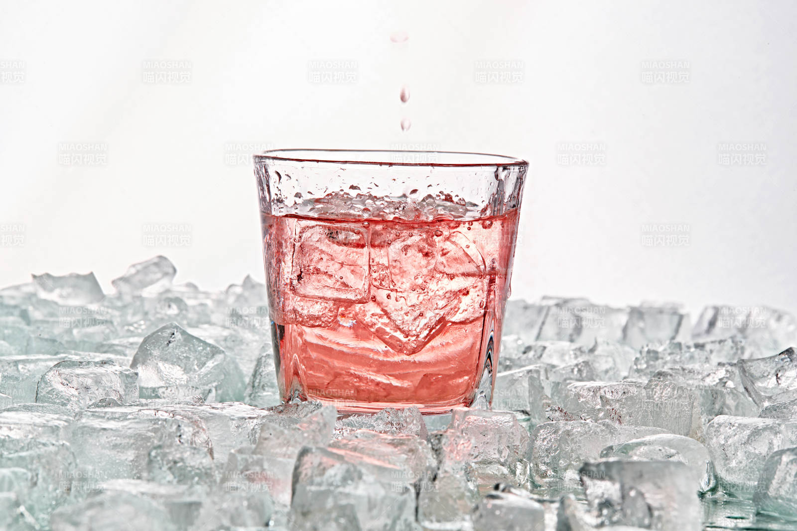 布满冰块的酒杯中的清凉桃子味预调酒图片