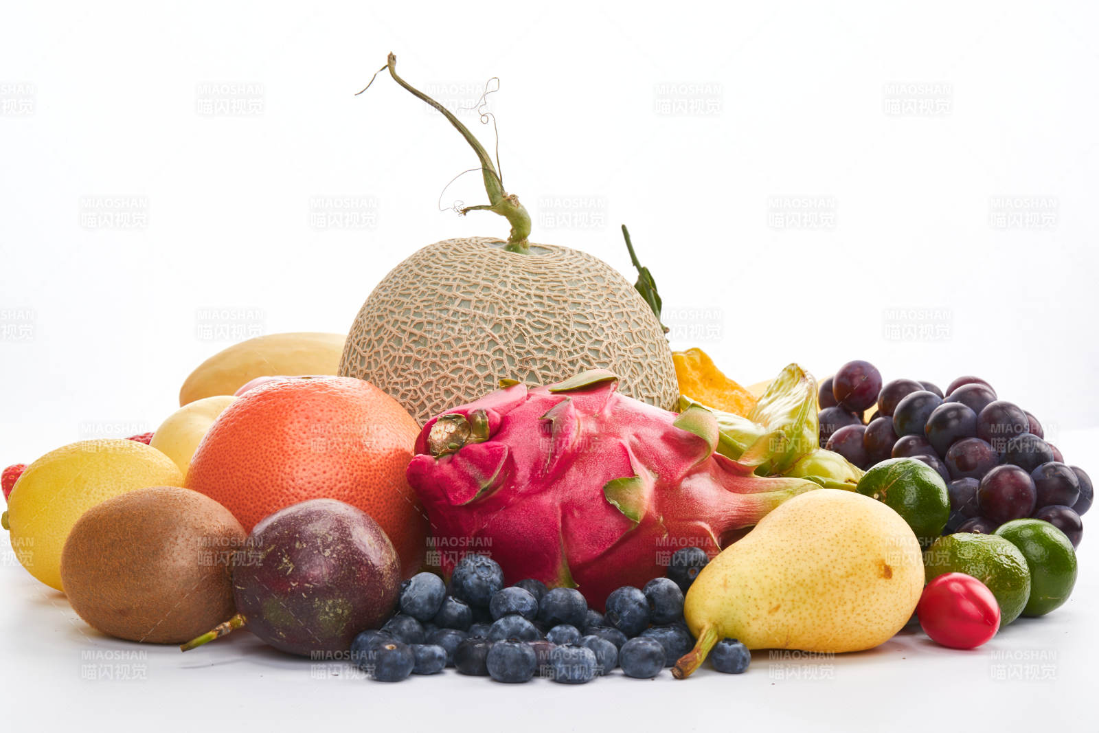 白色背景上摆放的生鲜混合水果图片