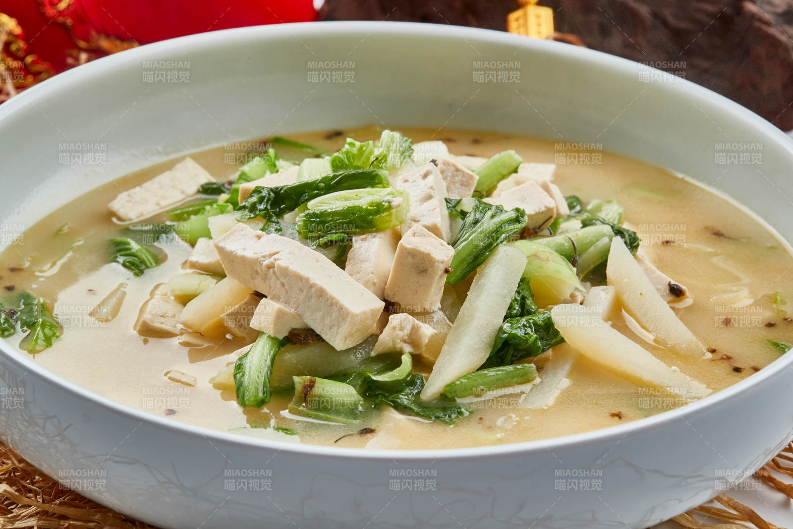 白色瓷餐具装的浓汤小白菜土豆炖豆腐图片