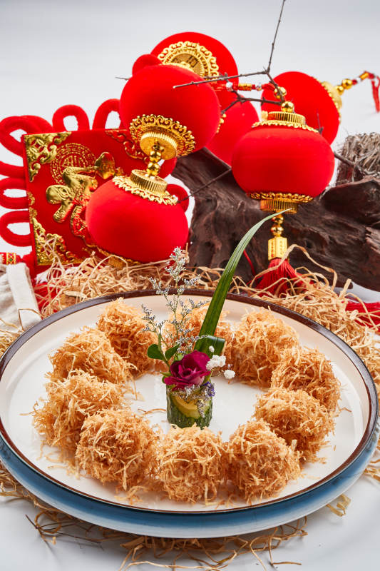 白色瓷盘装的金丝油炸大虾球图片