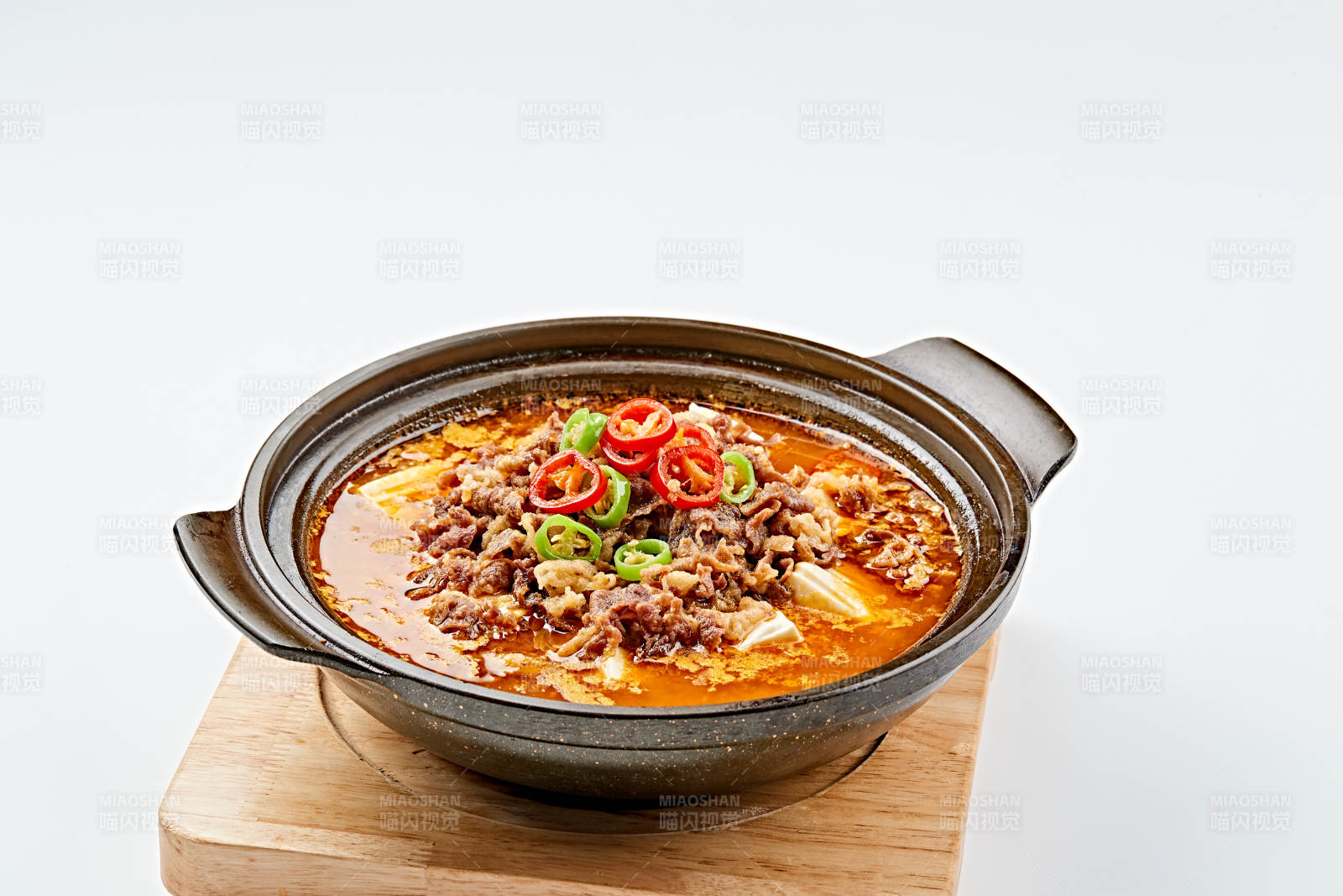 精美餐具装的砂锅香辣肥牛豆花图片