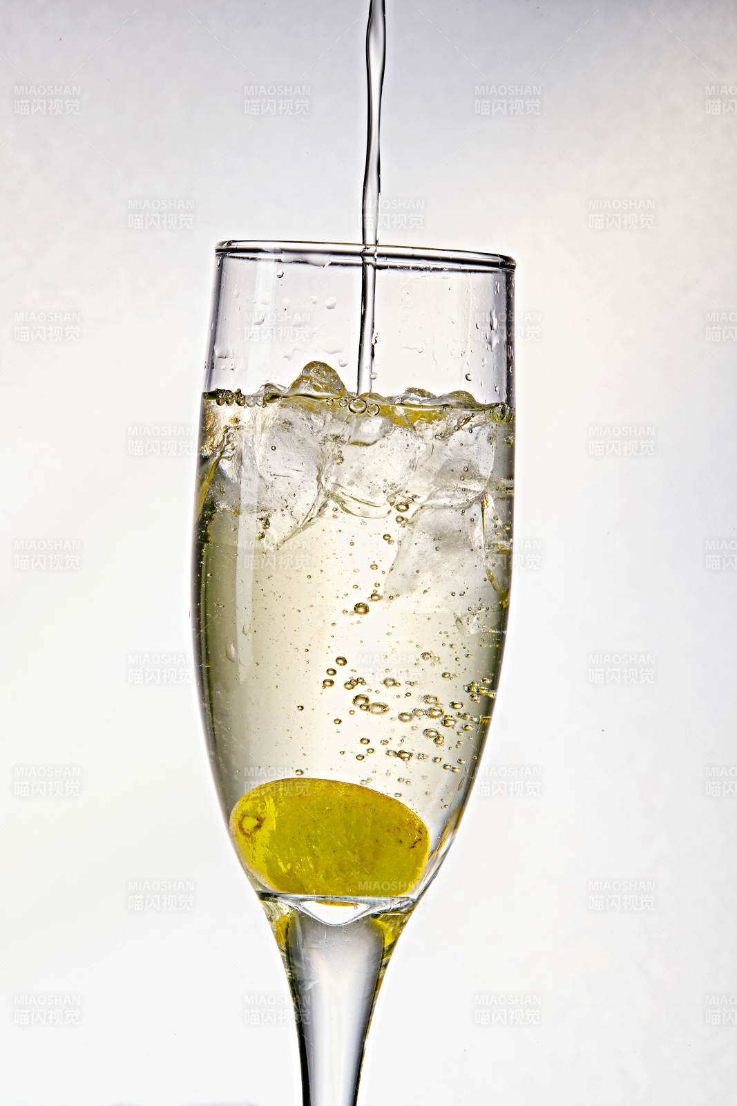 布满冰块的酒杯中的清凉白葡萄味预调酒图片