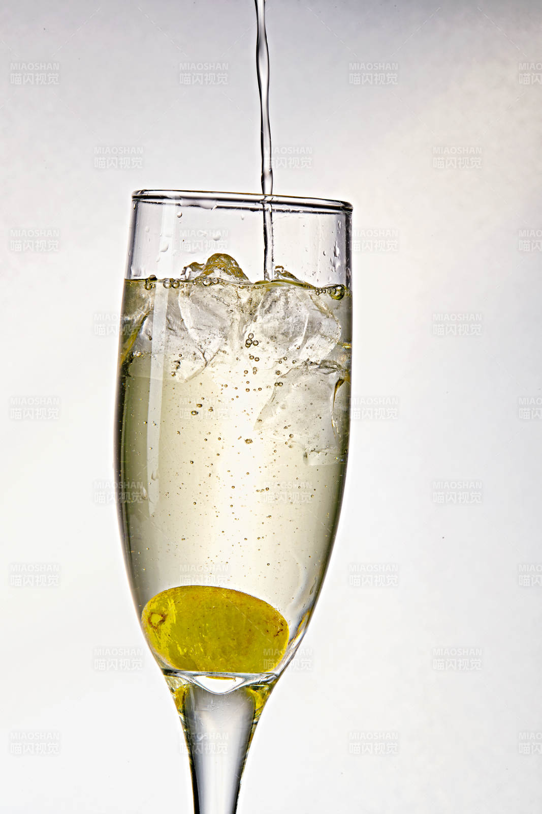 布满冰块的酒杯中的清凉白葡萄味预调酒图片