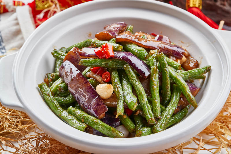 白色砂锅装的豆角茄子煲图片