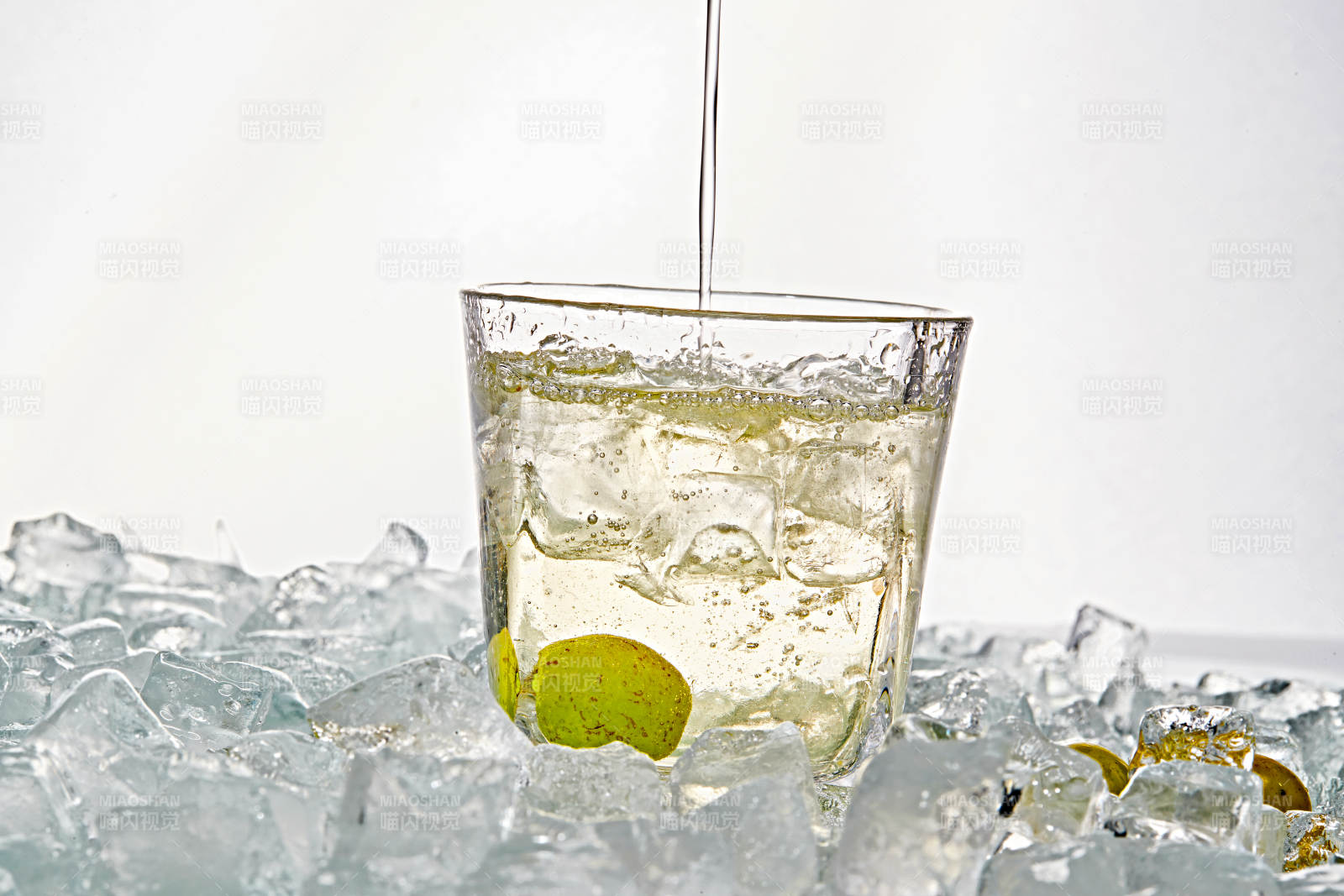 布满冰块的酒杯中的清凉白葡萄味预调酒图片