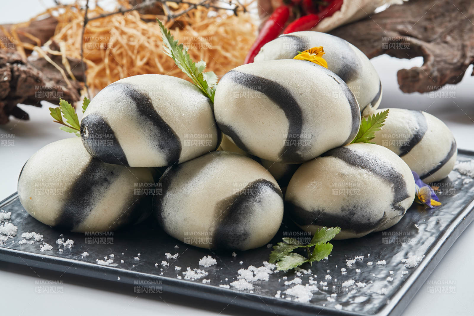 黑色瓷餐具装的大理石馒头图片