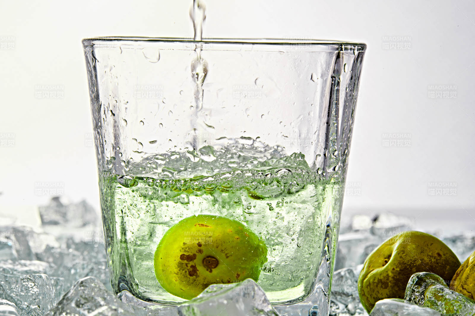 布满冰块的酒杯中的清凉白葡萄味预调酒图片