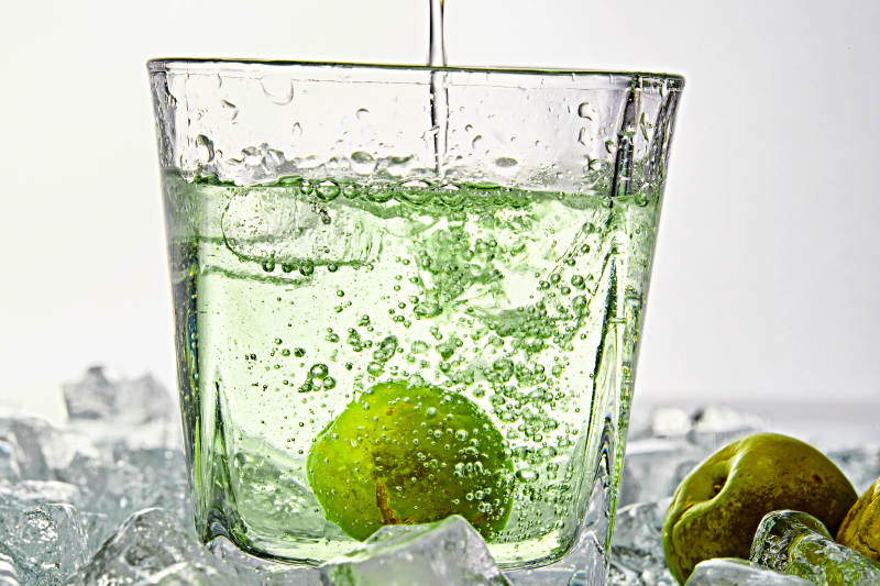 布满冰块的酒杯中的清凉白葡萄味预调酒图片