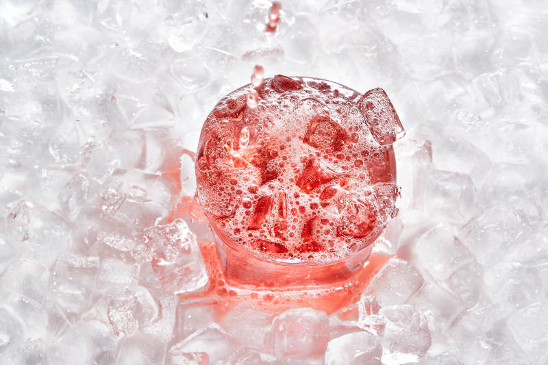 布满冰块的酒杯中的清凉葡萄味预调酒图片