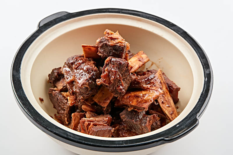 白色砂锅装的香煲酱香牛尾骨图片