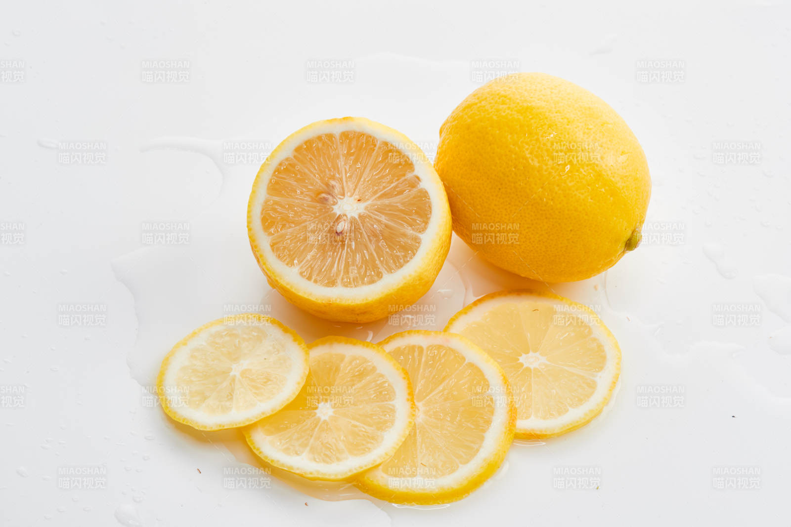 白色背景上摆放的新鲜水嫩柠檬及切片图片