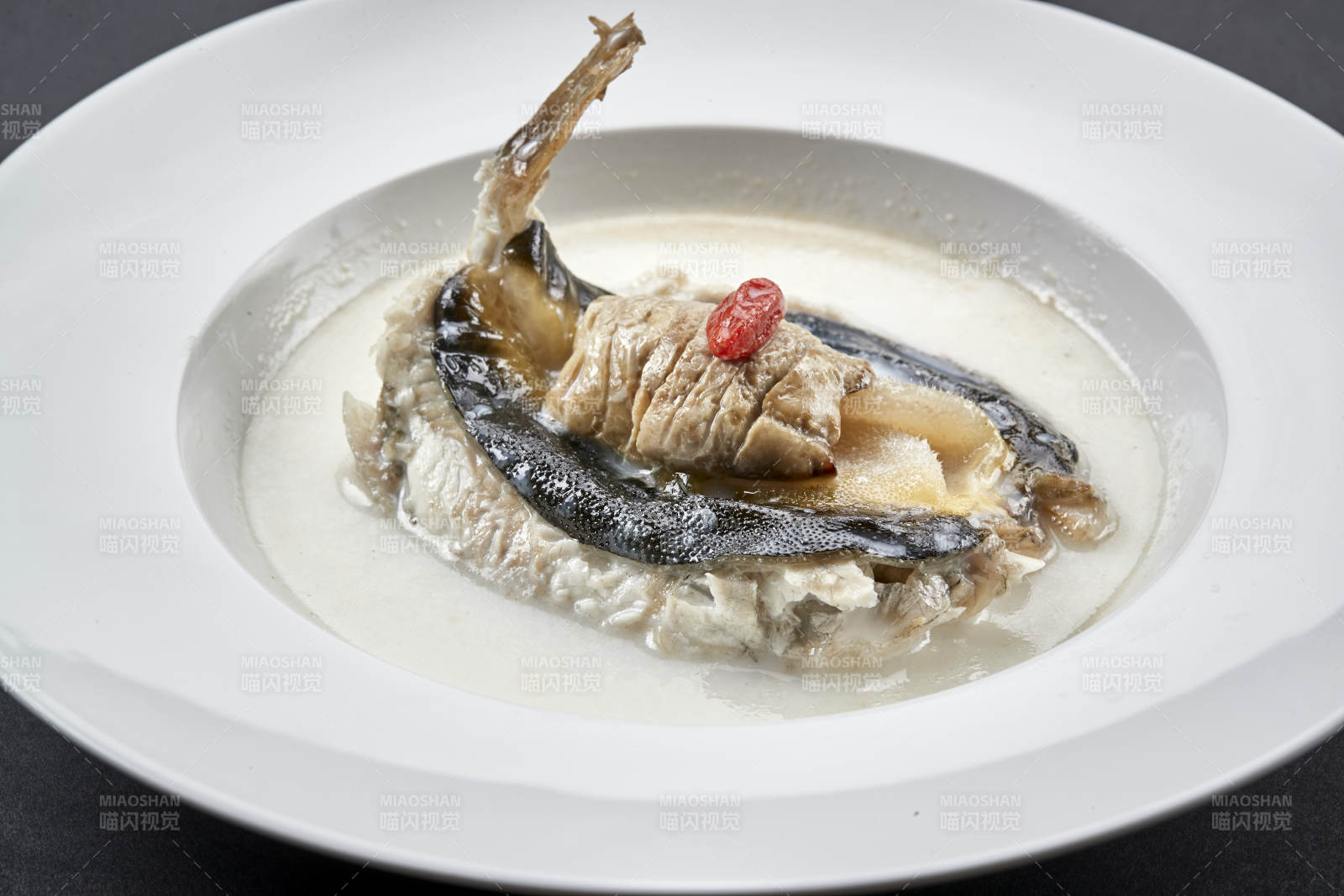 白色圆瓷盘装的时尚位菜奶汤炖小河豚图片