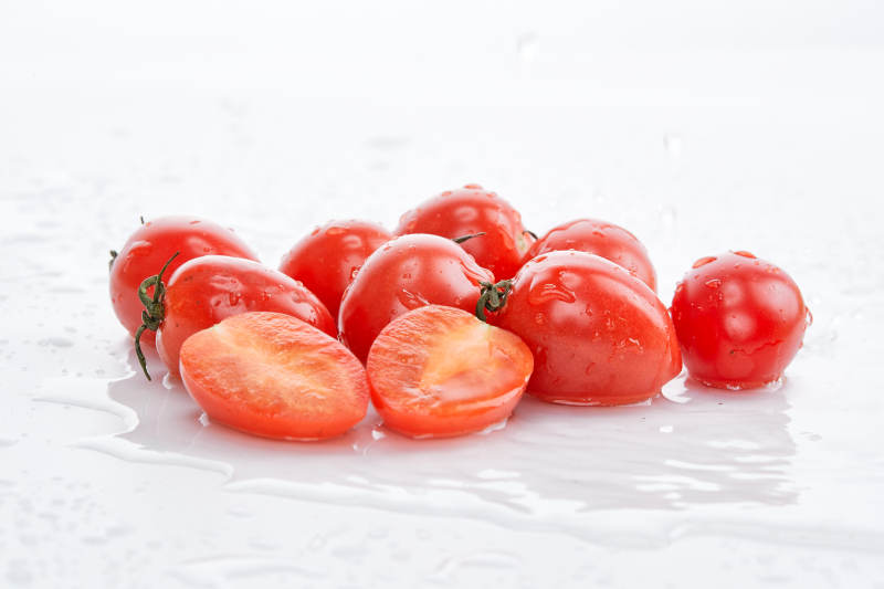 白色背景上摆放的鲜红圣女果图片