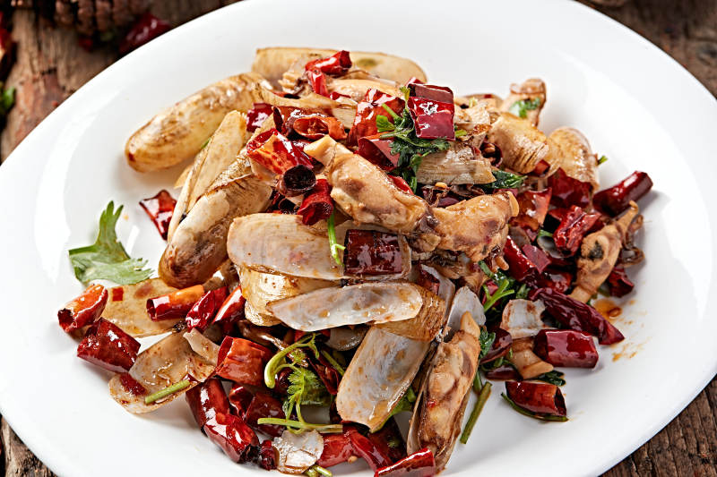 白色圆盘装的辣炒蛏子图片