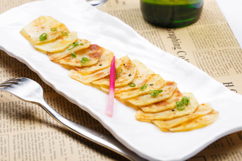 白色瓷盘装的椒盐香煎薯片图片