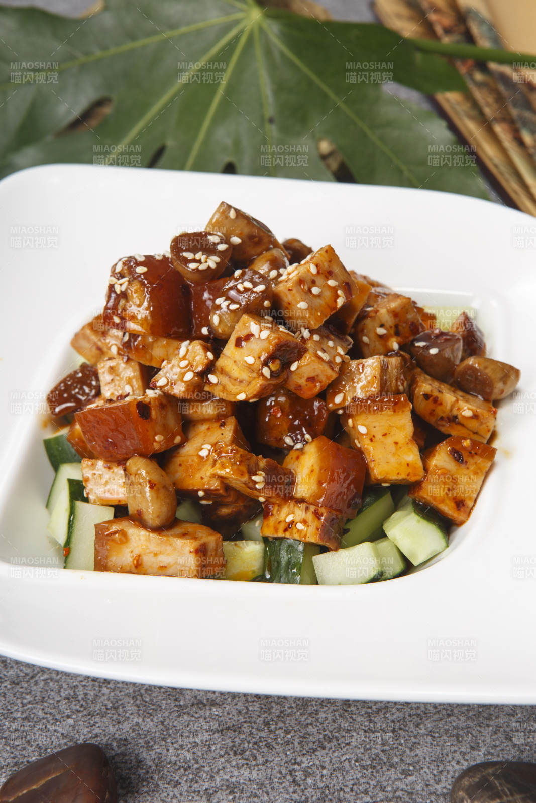 白色瓷盘装的酱香猪方肉图片