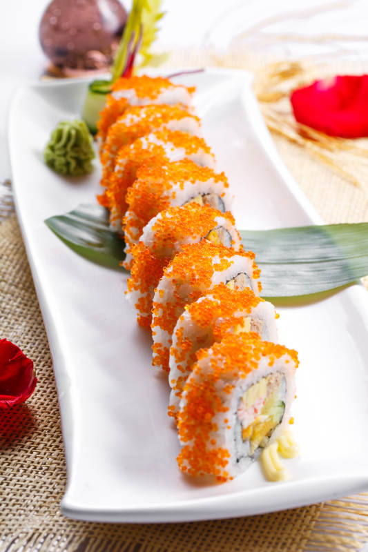 蟹子加州手卷寿司摆放在草垫上图片