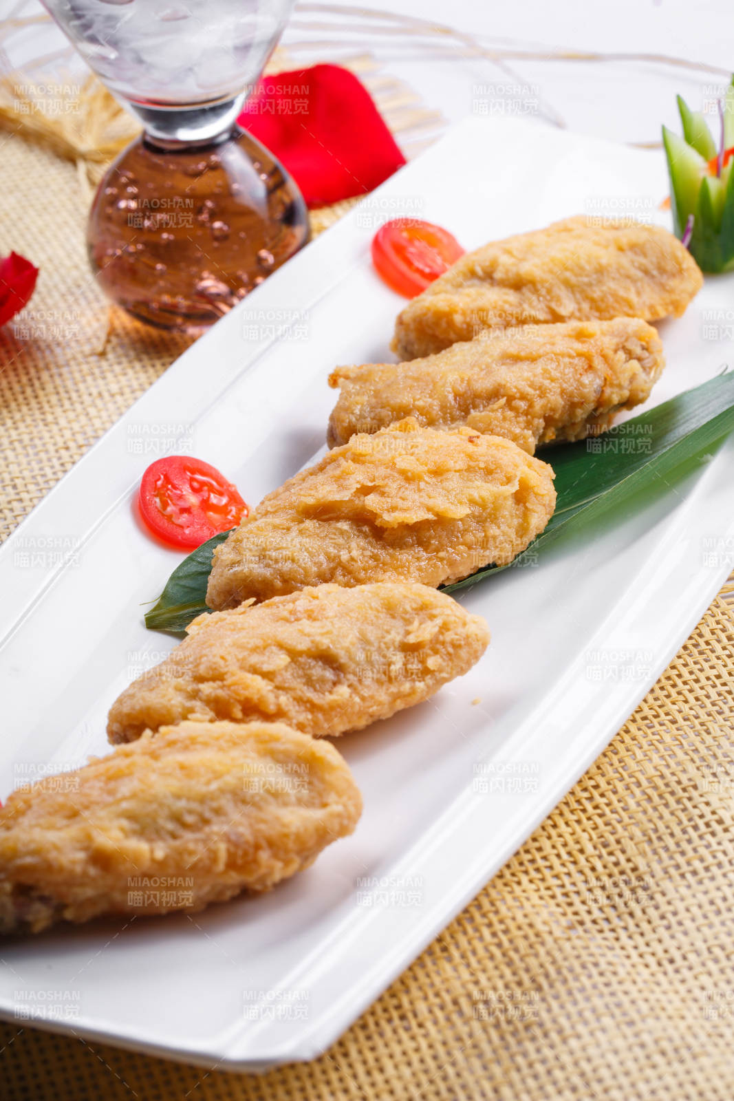 白色瓷盘装的香炸鸡翅中图片