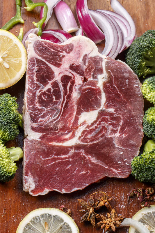 后牛腱肉摆放在木质砧板上图片