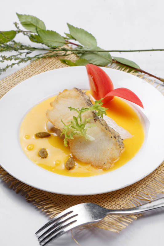 银鳕鱼佐法式南瓜酱摆放在草垫上图片