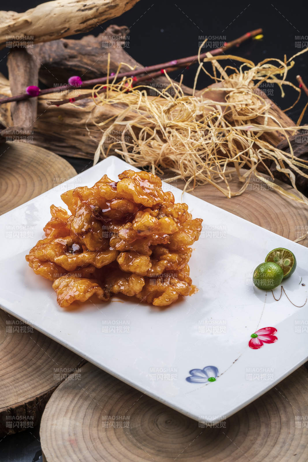 长方形瓷盘装的糖醋龙利鱼摆放在樟木砧板上图片