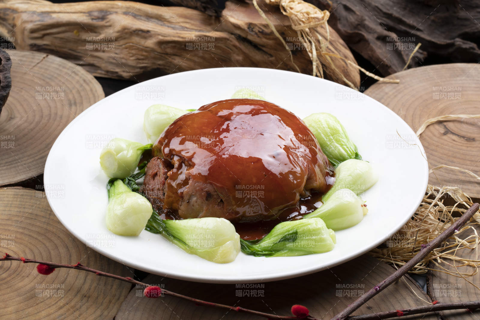 圆形瓷盘装的红焖扣肉摆放在樟木砧板上图片