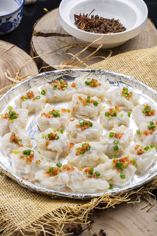 酒香铁板大虾球摆放在樟木砧板上图片