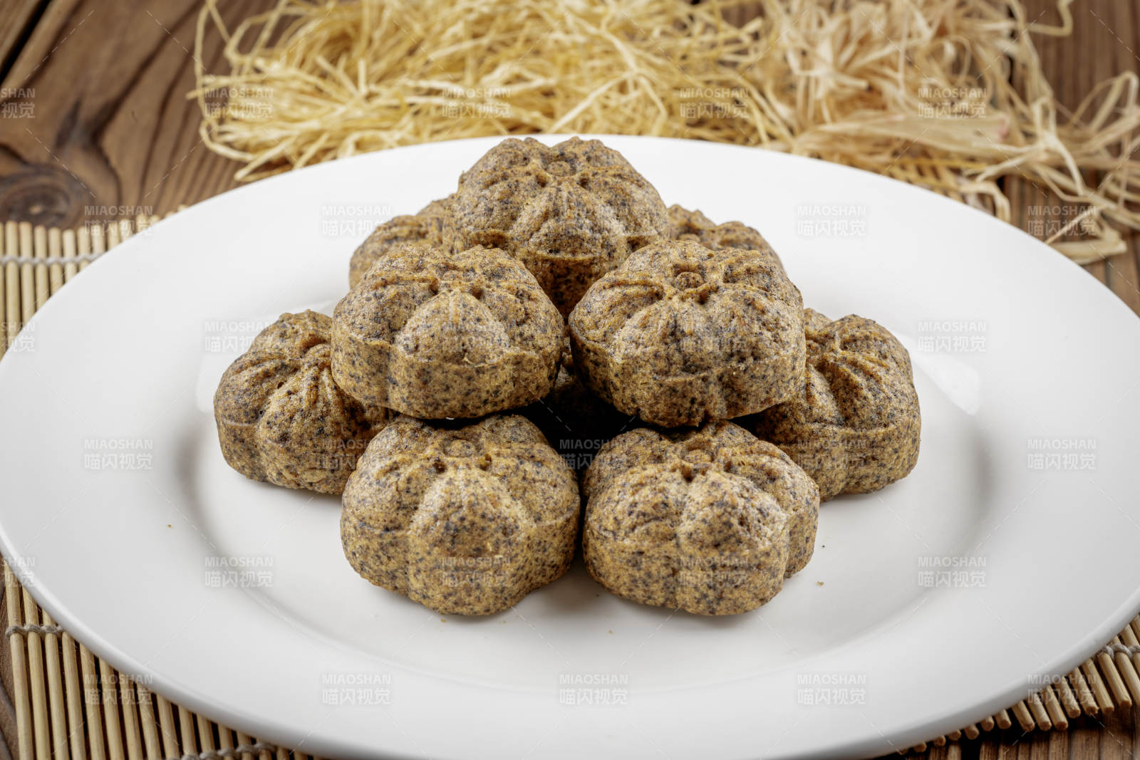 圆形白色瓷盘装的杂粮黑豆馍图片