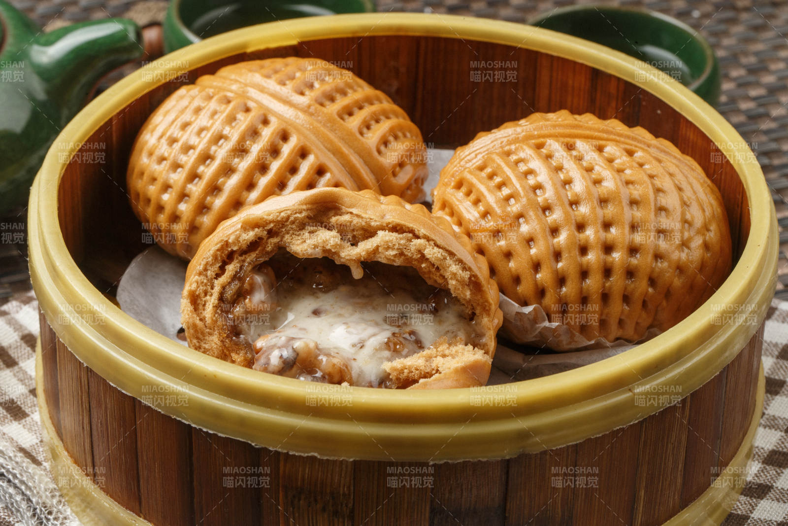 笼屉装的港式奶油菠萝包摆放在餐布上图片