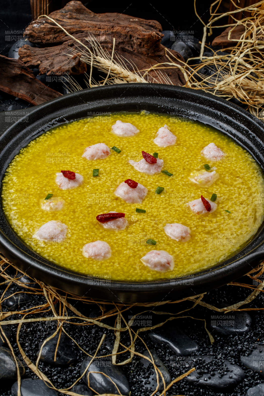 黑色砂锅装的金米虾丸图片