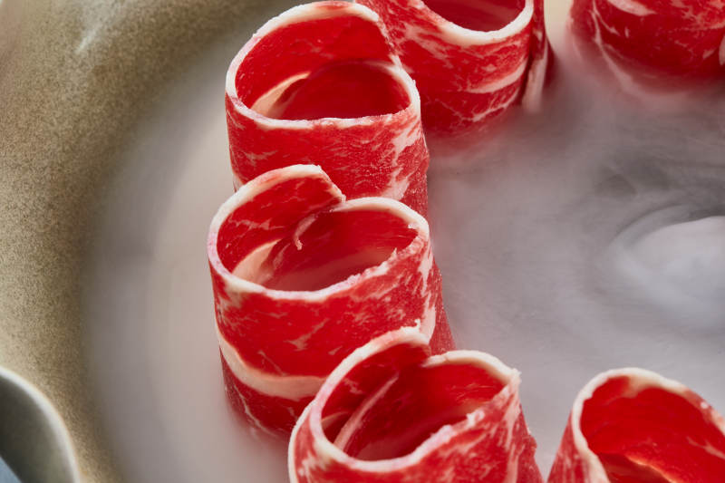 干冰缭绕的背景上摆放的雪花和牛卷图片