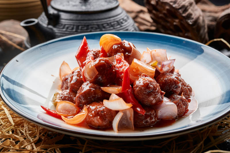 白色瓷盘装的红烧丸子图片