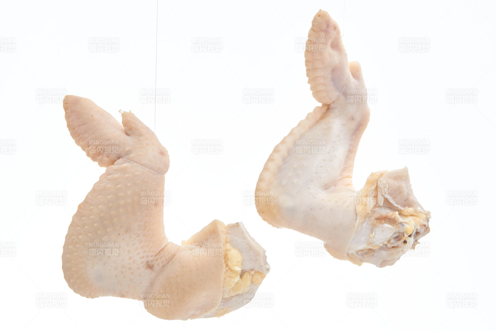 摆放在白色背景上分切好的生鲜鸡腿图片