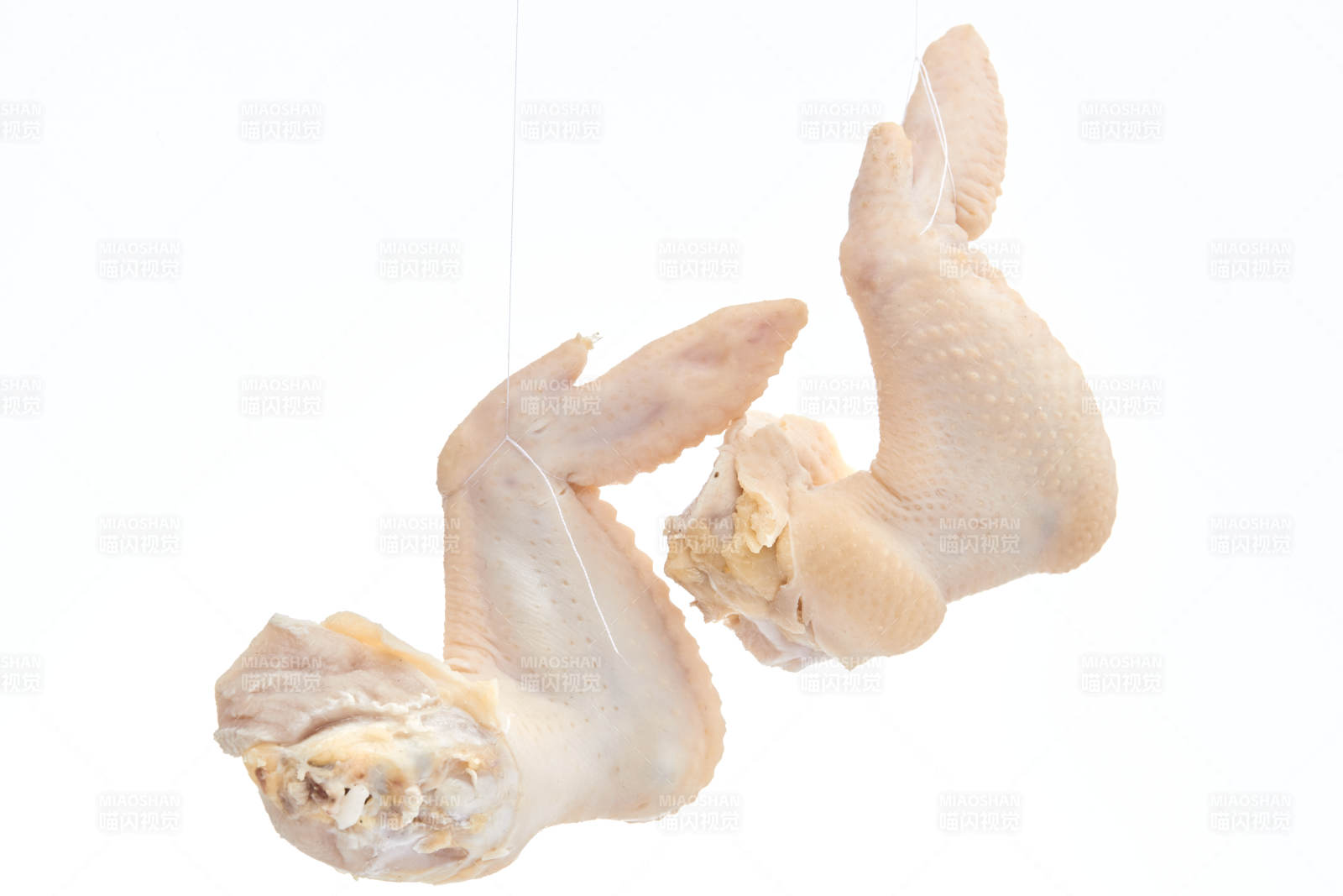 摆放在白色背景上分切好的生鲜鸡腿图片