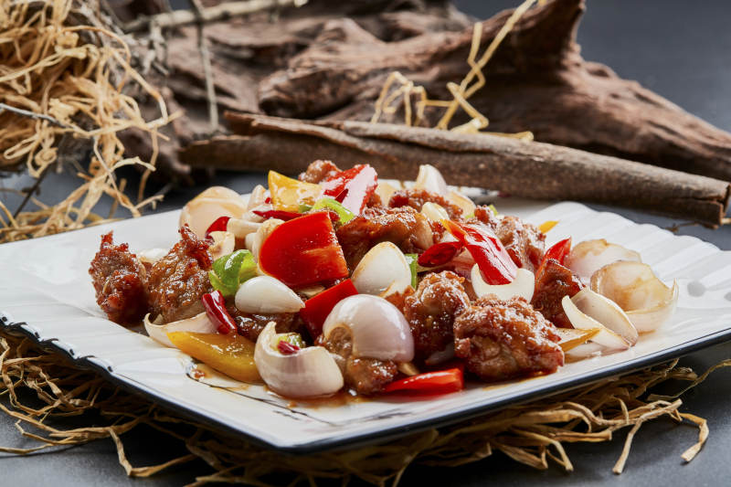 白色瓷盘装的彩椒洋葱猪小排图片