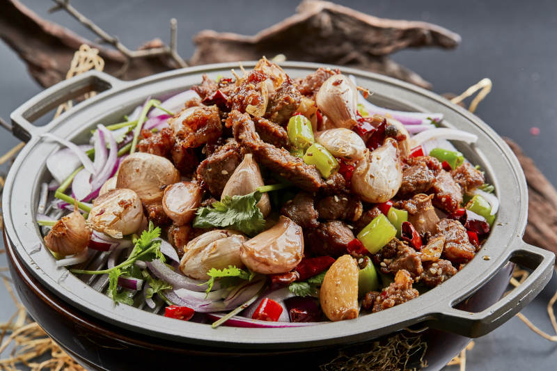 铁板餐具装的孜然毛蒜烧羊肉图片