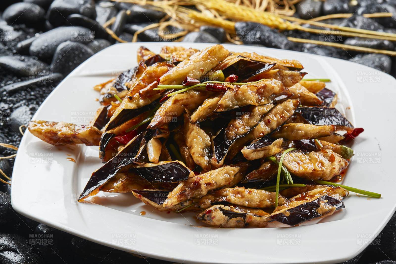 白色瓷盘装的香炸糖醋茄子块图片