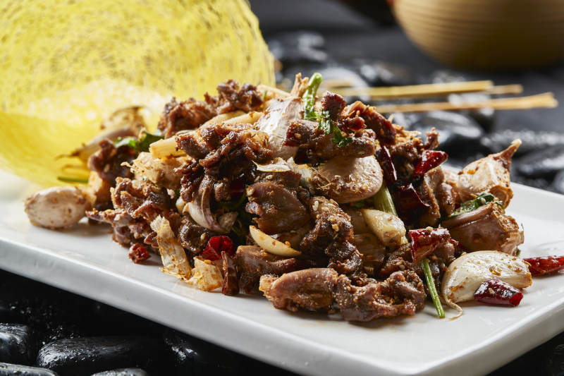 白色瓷盘装的的孜然辣椒毛蒜烧鸡胗图片