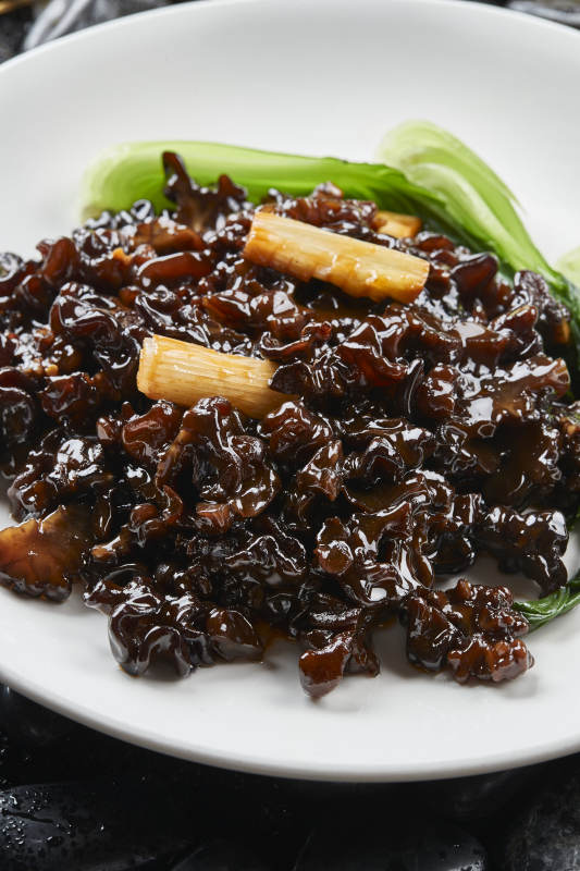 白色瓷盘装的葱烧木耳黑皮参图片