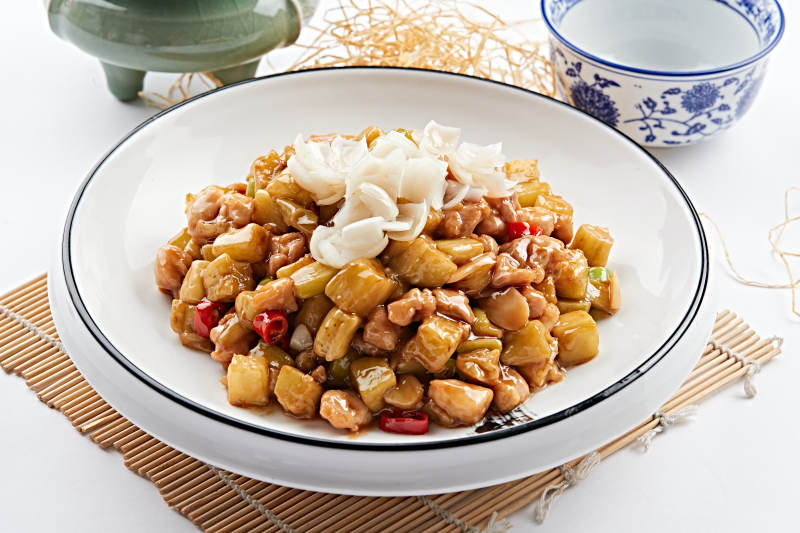 圆形白瓷盘装的百合爆茄丁图片