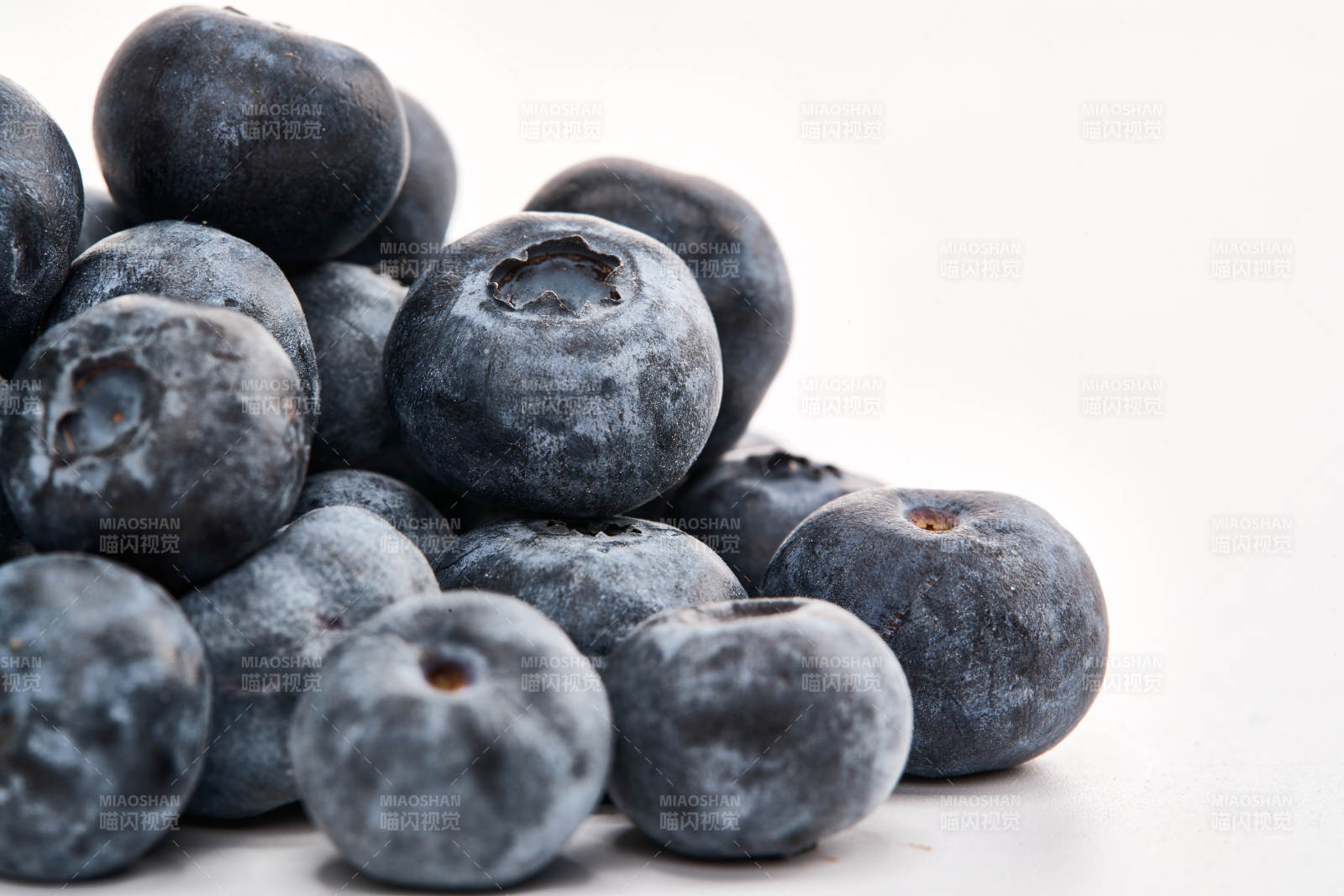 白色背景上摆放的水润新鲜蓝莓果图片